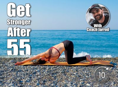 Young slim woman in tight sportswear doing thread the needle pose on orange yoga mat outdoors at pebble beach by the sea. Yoga at nature concept. 6 Morning Moves That Keep You Stronger Than Most 30-Year-Olds After 55. Cover