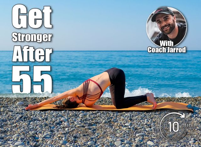 Young slim woman in tight sportswear doing thread the needle pose on orange yoga mat outdoors at pebble beach by the sea. Yoga at nature concept. 6 Morning Moves That Keep You Stronger Than Most 30-Year-Olds After 55. Cover