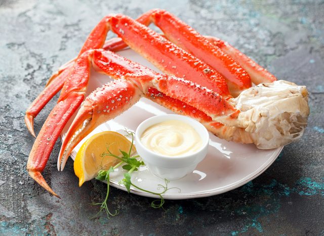 Crab legs with mayonnaise sauce, selective focus