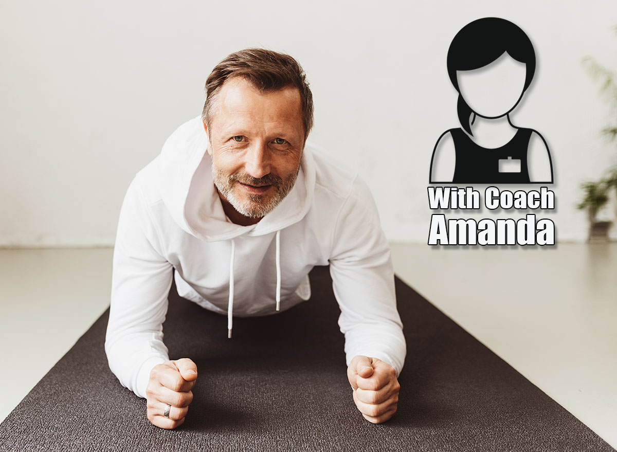 Portrait of a determined middle-aged man smiling while exercising plank on the forearms on a mat on the floor as workout routine at home during pandemic. If You Can Hold This Position for 90 Seconds After 45, Your Core Is Stronger Than 85% of Your Peers. Cover