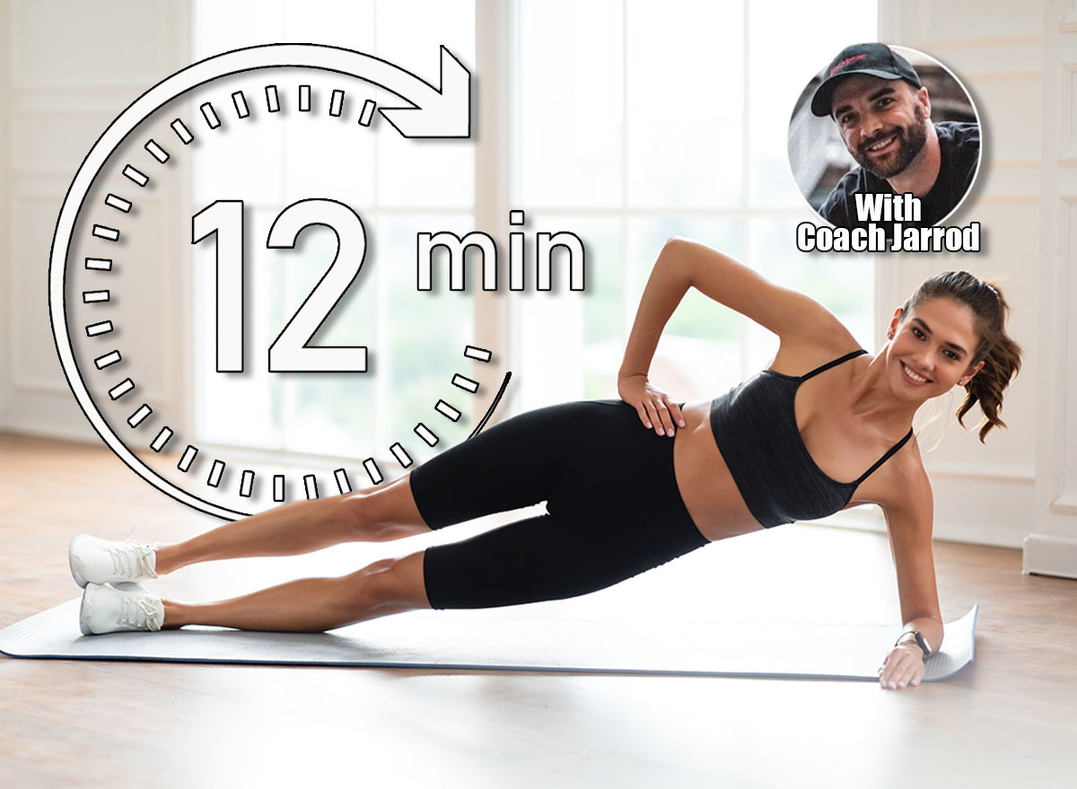 Body Shaping Concept. Smiling Fit Woman Standing In Side Plank Position On Yoga Mat Near Window At Home Or Fitness Studio, Looking Posing At Camera, Training Core And Abs Muscles, Free Copy Space. 4 Core Moves That Flatten Your Stomach Faster Than Crunches After 45 Cover