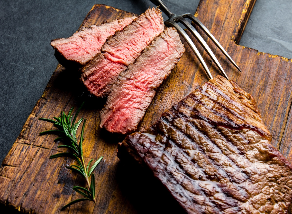 Sliced,Grilled,Medium,Rare,Beef,Steak,Served,On,Wooden,Board