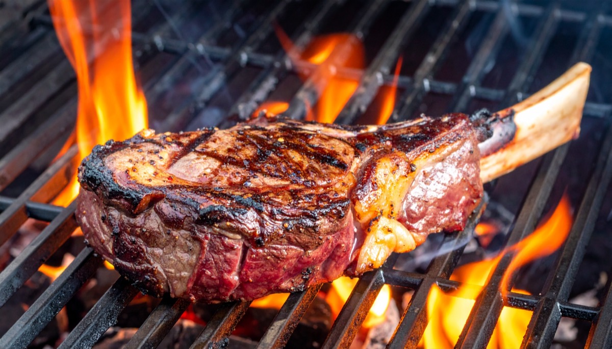 Grilled,Usda,Prime,Angus,Beef,Tomahawk,Steak,Sizzling,On,Charcoal