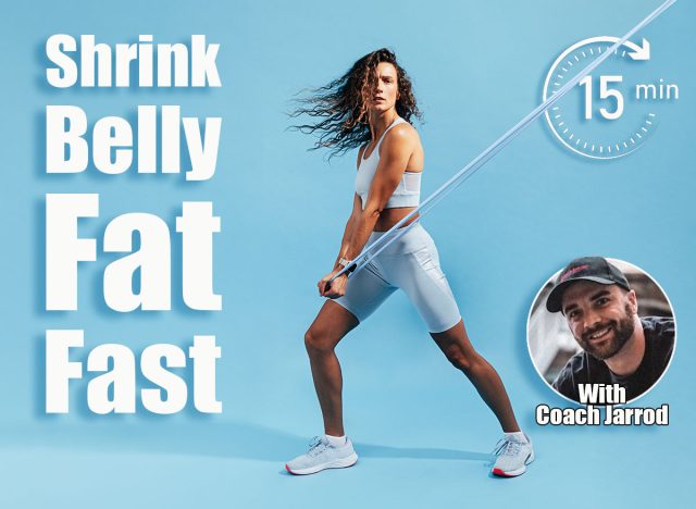 Female athlete doing intense stretching exercises with elastic band. Healthy woman in sportswear working out on blue background. 7 Standing Ab Exercises That Shrink Belly Pooch After 50, Cover,