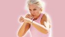 Mature woman doing sport in a coastal port. Arm training throwing boxing punches. Female doing shadow boxing outdoors. 5 Standing Exercises That Tighten Arm Jiggle in 21 Days After 50. Cover