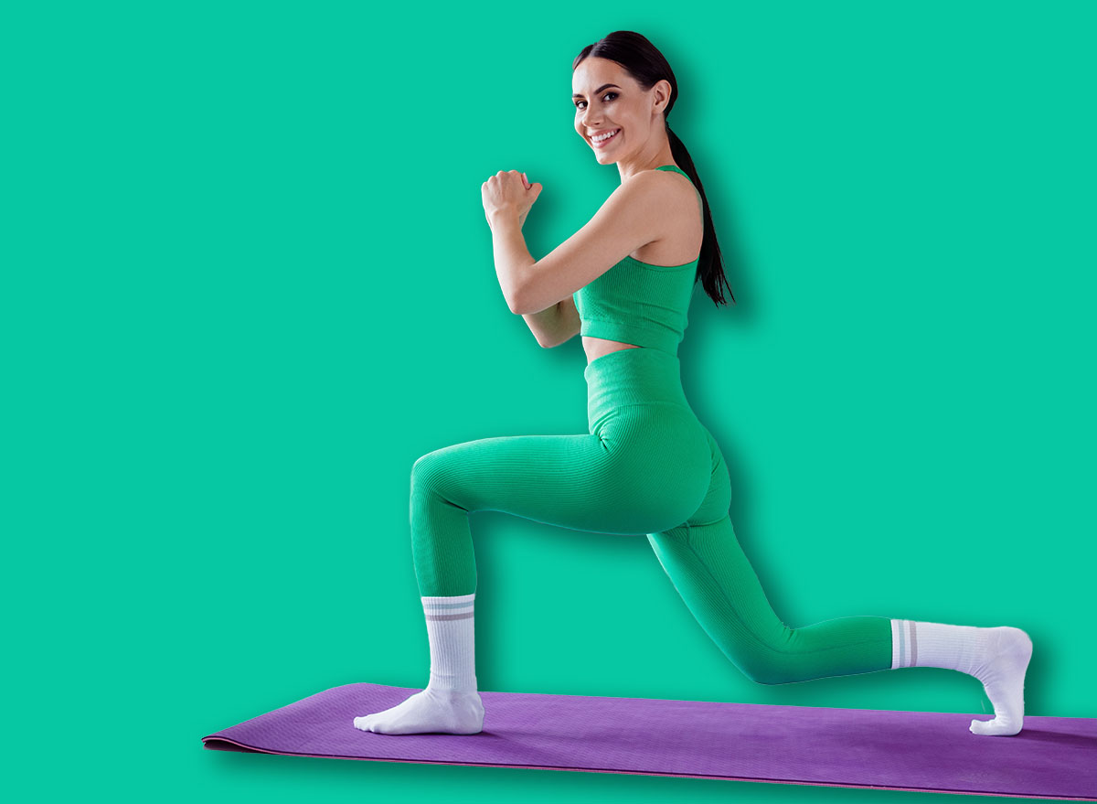 Full length photo of adorable positive lady wear sporty outfit stretching legs smiling indoors home studio