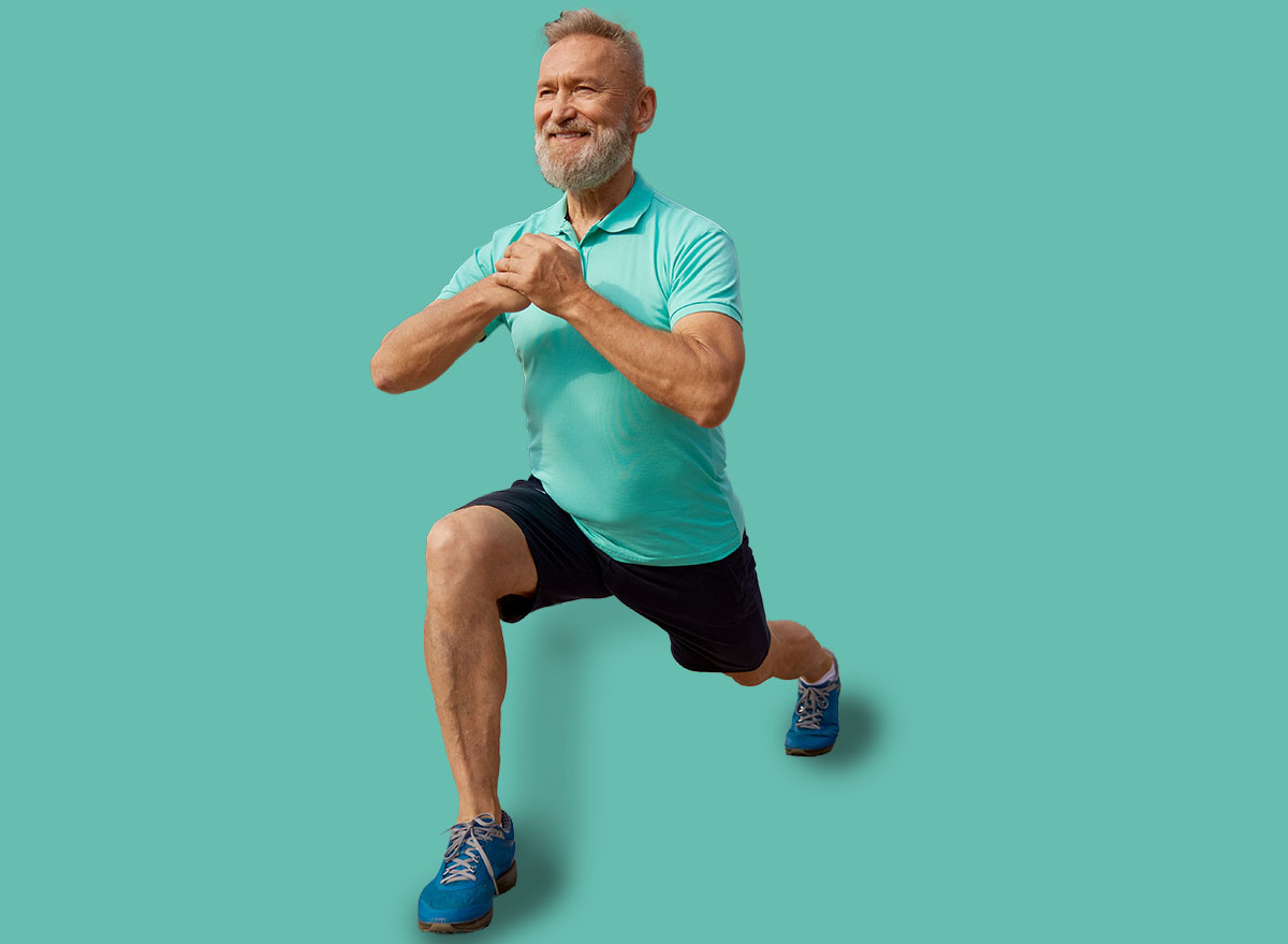 Senior man doing lunges physical exercises at sport field outdoors