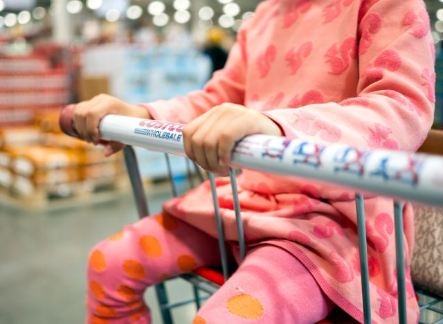 A child sitting in a Costco shopping cart