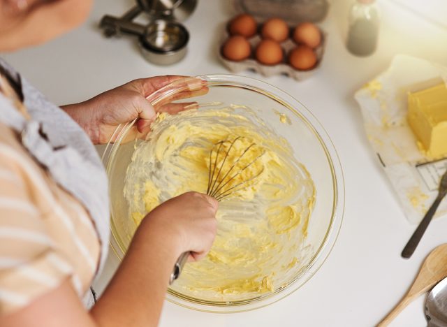 Woman, hands and ingredients for cookies in kitchen for biscuits, bread and breakfast in cafe. Female nutritionist, cooking and dessert for bakery, small business and startup coffee shop in New York