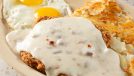 A closeup view of a country-fried steak entree.