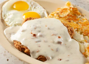 A closeup view of a country-fried steak entree.
