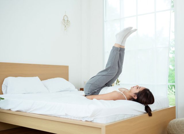 Young Asian woman doing exercise workout in bedroom at home