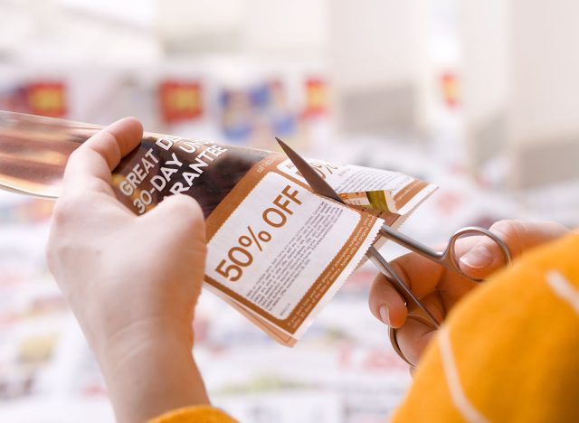 Woman cutting abstract discount coupon