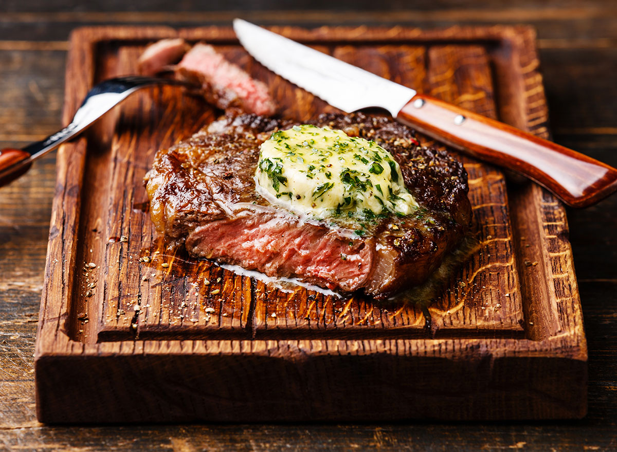 Grilled,Medium,Rare,Steak,Ribeye,With,Herb,Butter,On,Cutting