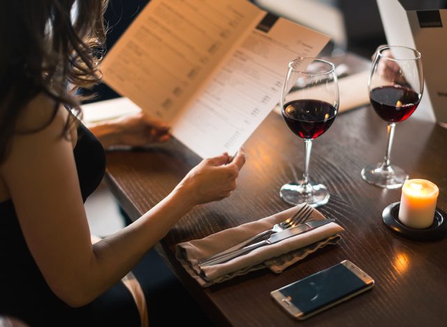 Cheerful couple with menu in a restaurant making order