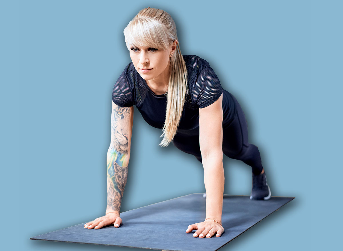 Fit woman doing pushup exercise during home workout