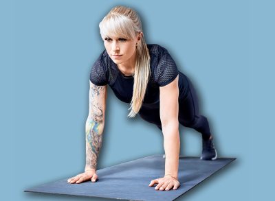 Fit woman doing pushup exercise during home workout