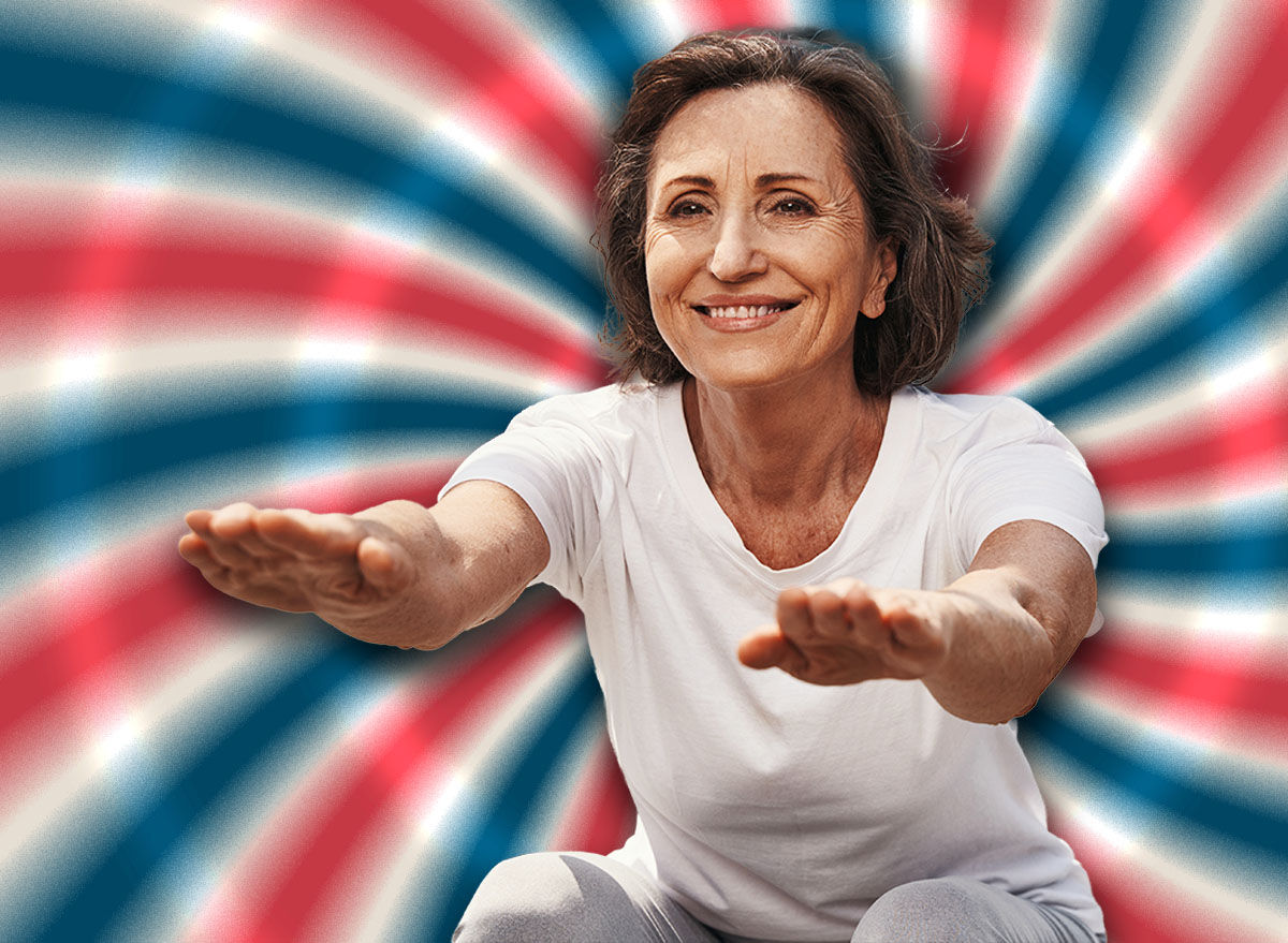 Happy elderly fit woman doing squats outdoors