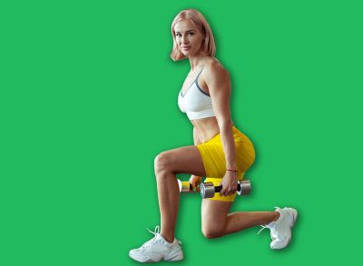 Athletic muscular woman trains leg muscles with dumbbells doing lunges in a modern gym. Beautiful female with perfect body. Healthy lifestyle