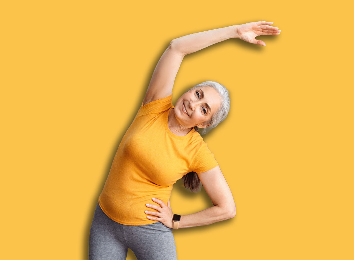 Happy senior woman having workout at home, cheerful aged lady in sportswear exercising on yoga mat, looking at camera and smiling, full length shot. Sport for seniors
