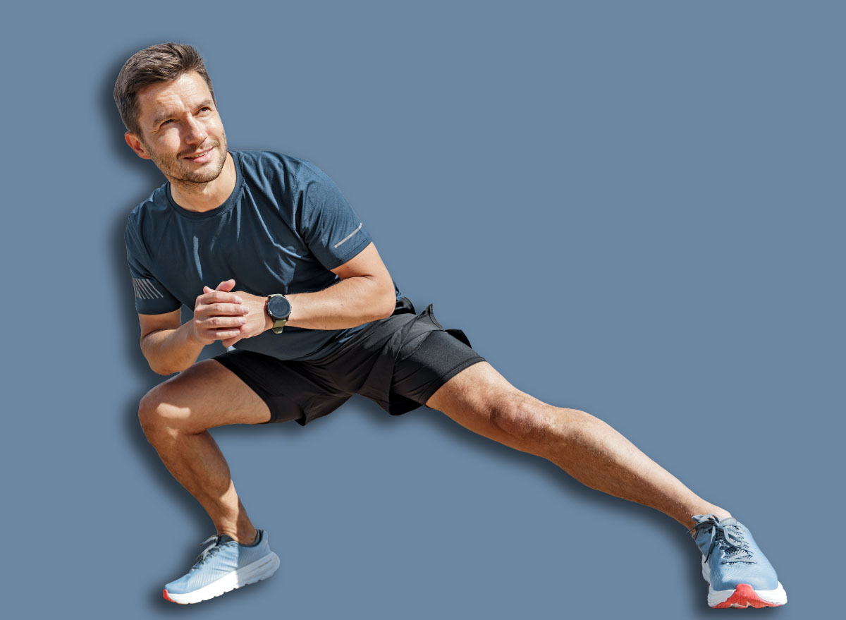 Man,Performing,A,Lateral,Lunge,Exercise,By,The,Waterfront,On