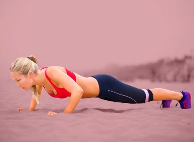 Woman, pushup and training by beach, exercise and practice for strength in sportswear. Female person, outdoors and fitness for healthy body on sand, muscle and cardio challenge for active workout