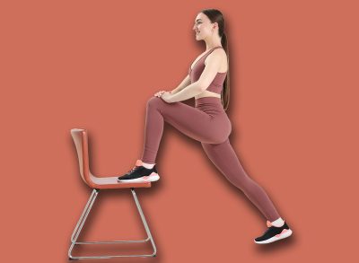 Beautiful woman exercising with chair at home