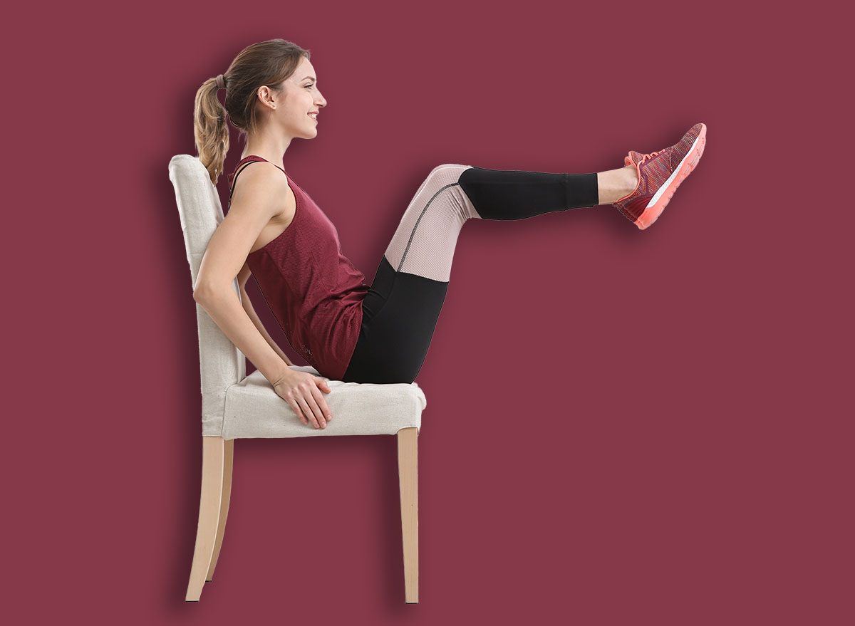 Young woman exercising with chair indoors. Home fitness
