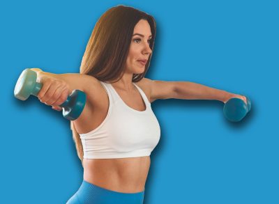 Fitness woman holding dumbbells. Fitness instructor in the sport room background. Female model with muscular fit and slim body.