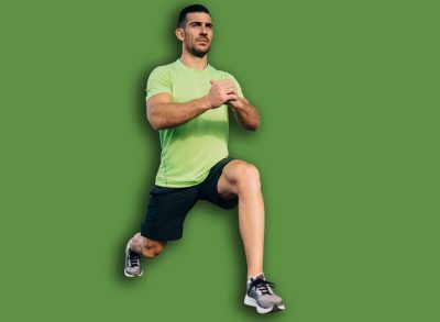 Full body handsome mature ethnic male in summer sportswear doing forward lunge on left leg with hands together while doing workout against contemporary geometric building