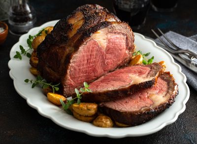 Boneless beef roast on a serving platter sliced for a holiday dinner