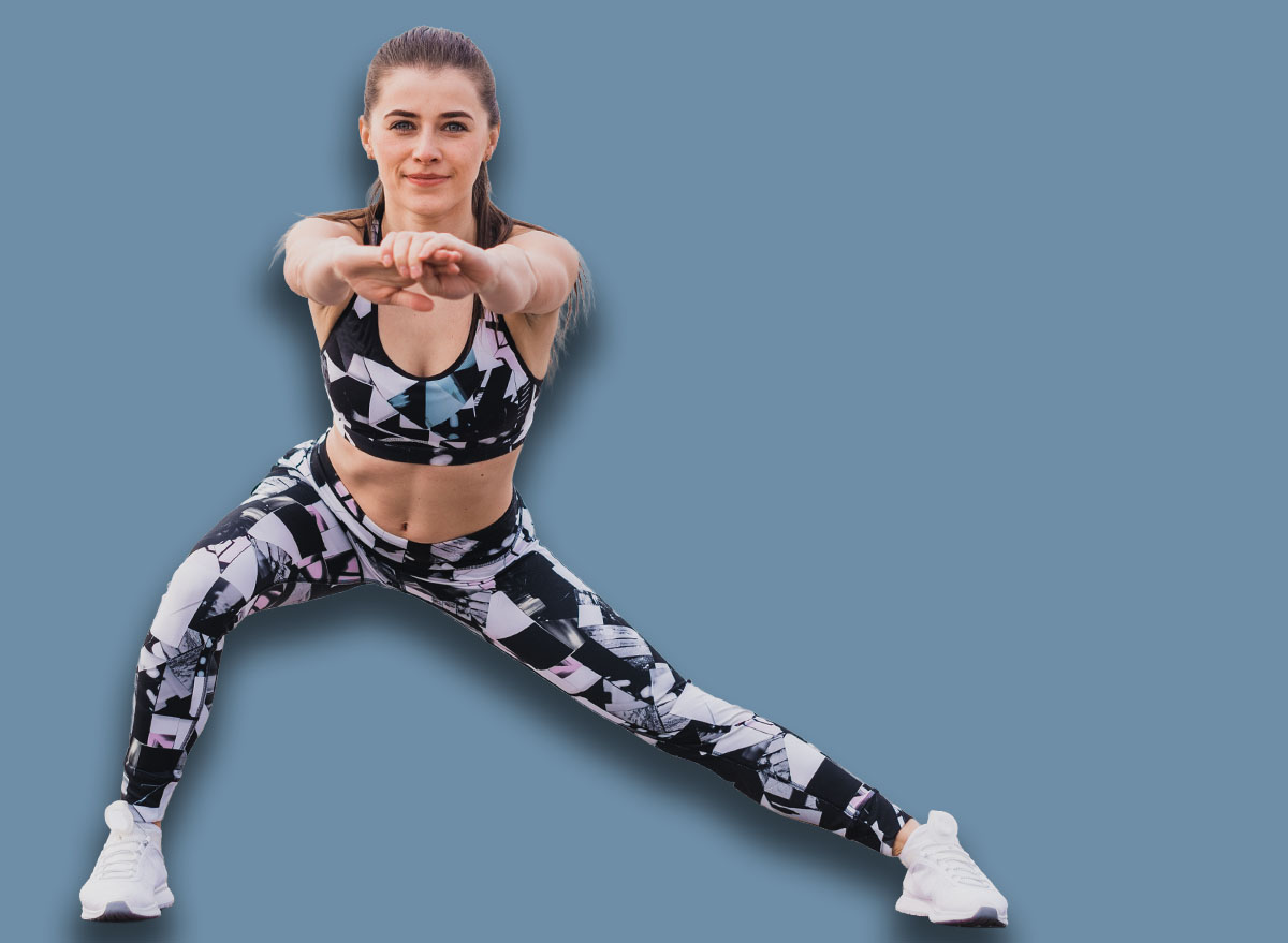 Woman doing walking lunges outdoors overlooking the river. Fitness, sport and healthy lifestyle concept.