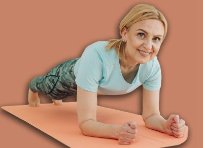 Sporty middle-aged caucasian woman standing in plank position using laptop for training at home