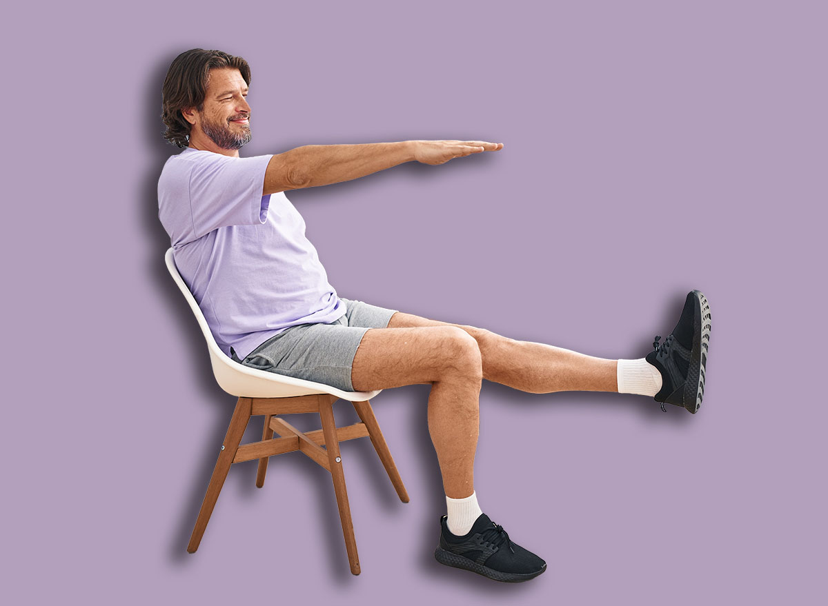Middle age man smiling confident sitting on chair stretching at sport center