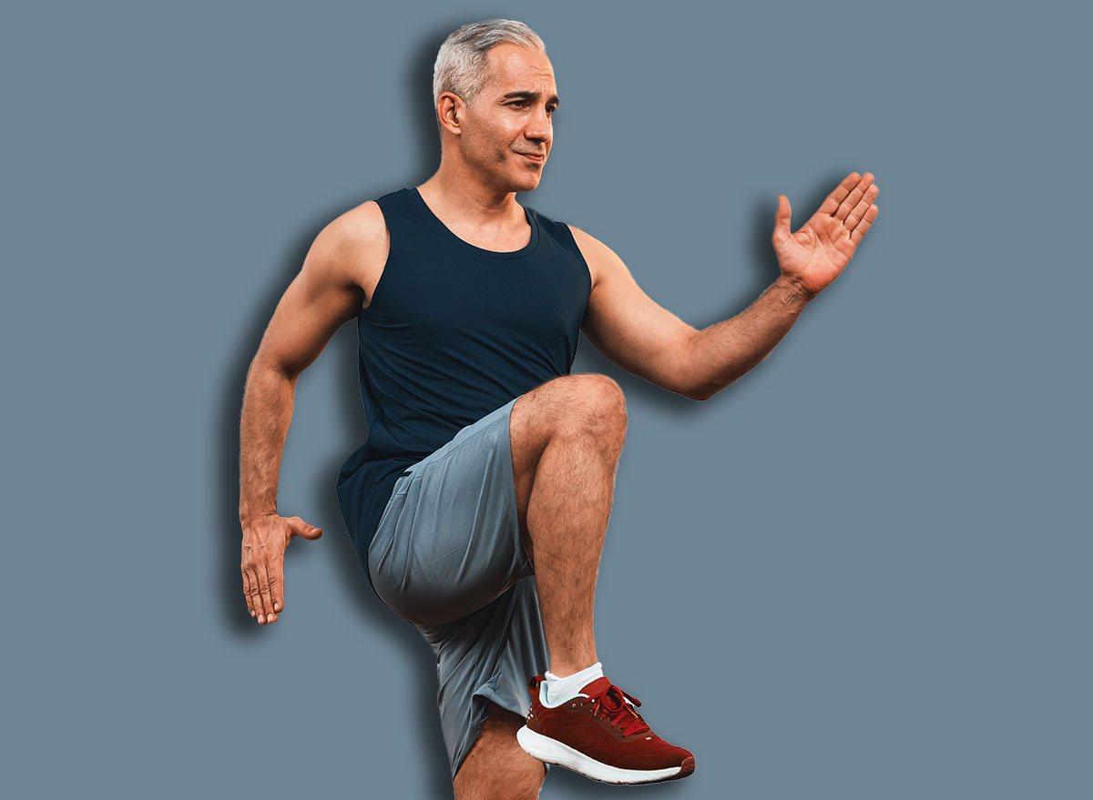 Athletic and sporty senior man make running pose at home. Healthy fit body lifestyle as home workout exercise concept after retirement. Clout