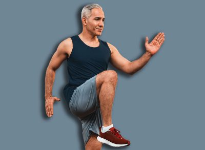 Athletic and sporty senior man make running pose at home. Healthy fit body lifestyle as home workout exercise concept after retirement. Clout