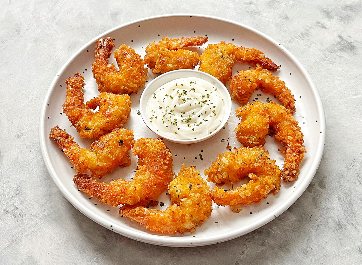 Coconut shrimp served on white plate.