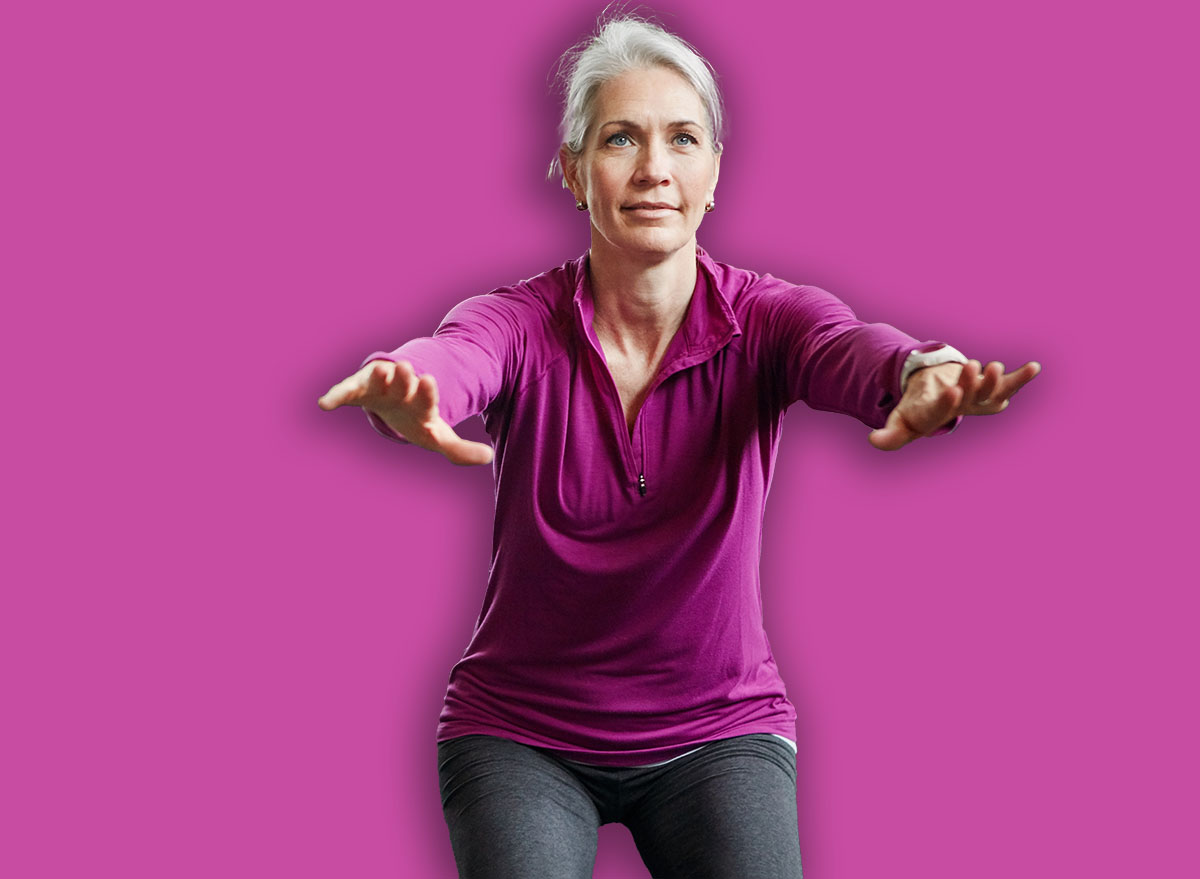 Mature group, woman and squat with fitness in gym, balance or coach for muscle development in class. Senior group, men and exercise for legs, health or workout together in retirement at wellness club