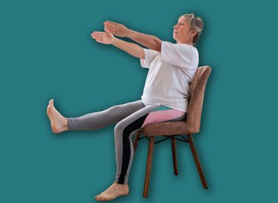 Senior caucasian woman doing yoga at home on chair