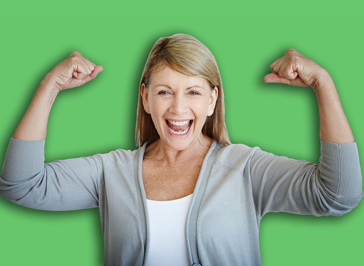Flexing, portrait and smile with mature woman in studio on gray background for achievement or victory. Arms, bicep and winner with strong person showing muscles for health goal, motivation or success