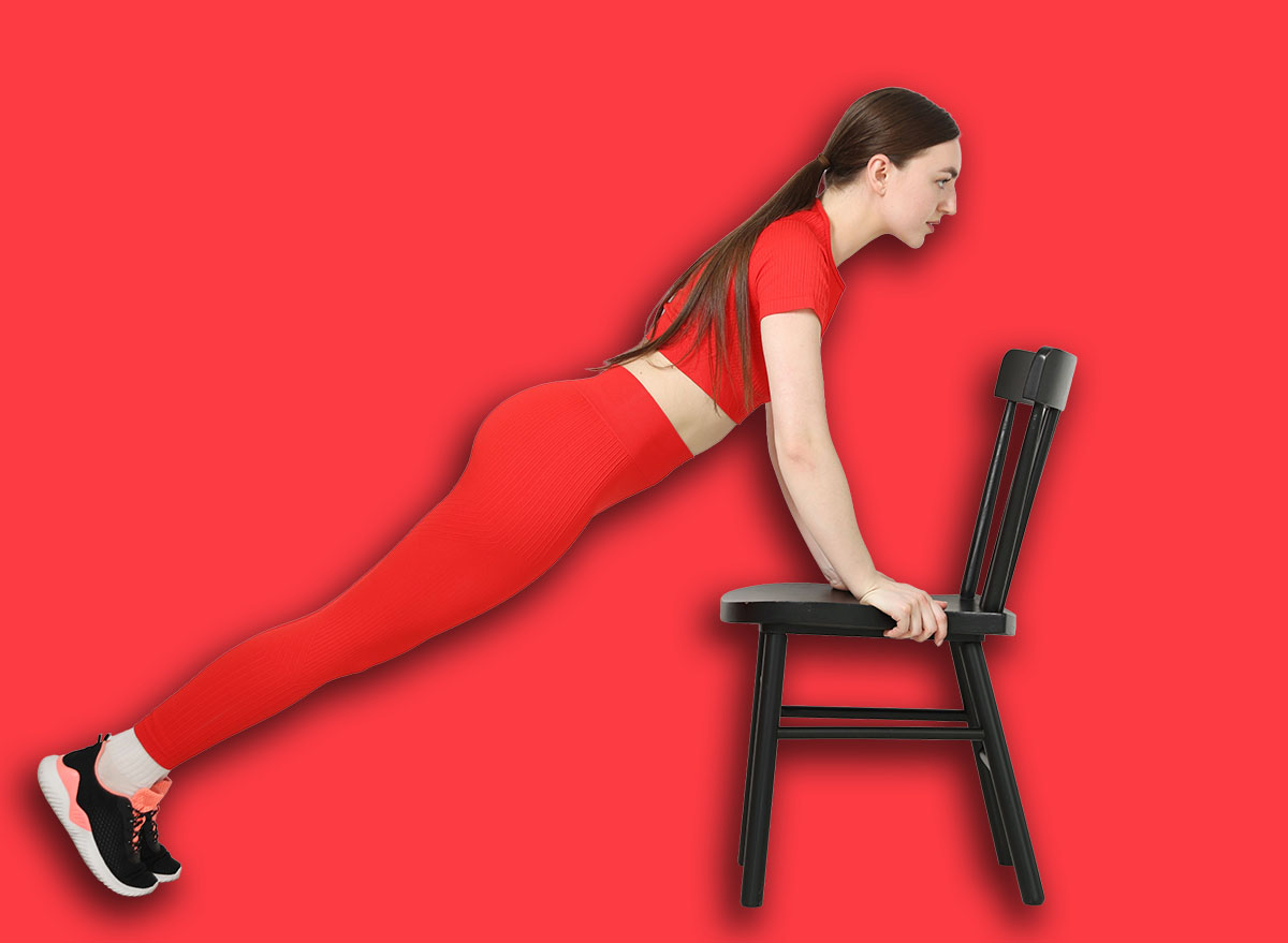 Beautiful woman exercising with chair at home