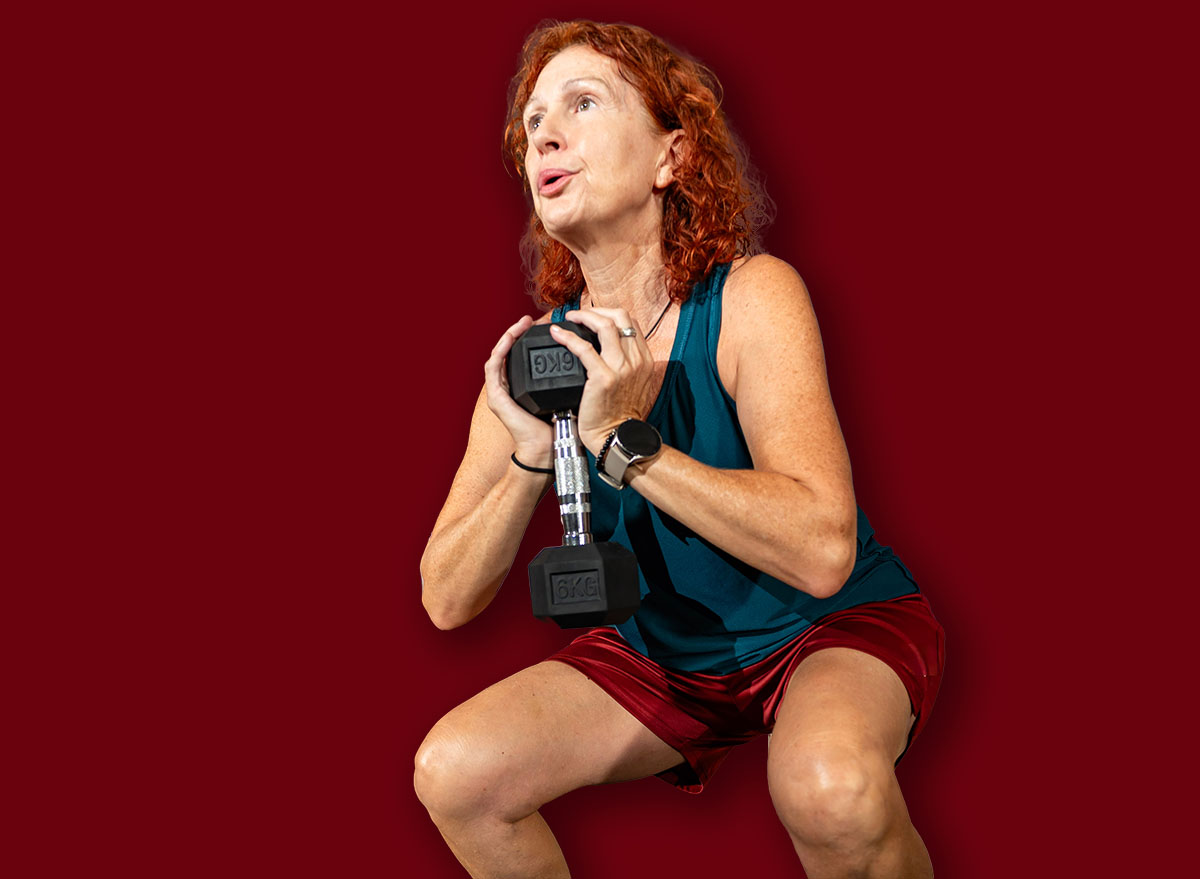 Woman performing goblet squat exercise in gym to build muscle and fitness