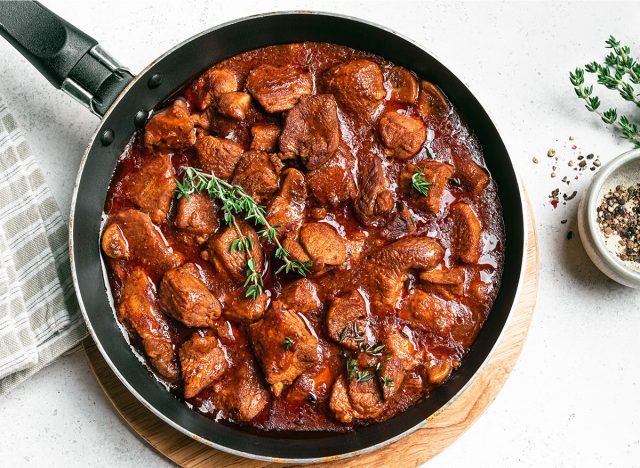 Red Wine Braised Beef or Beef Bourguignon Stew, top view. Hearty comfort meal for winter holidays, slow cooking.