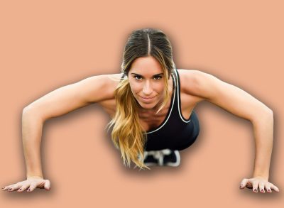 Young beautiful woman doing pushups in the gym. Girl wearing sportwears clothes.