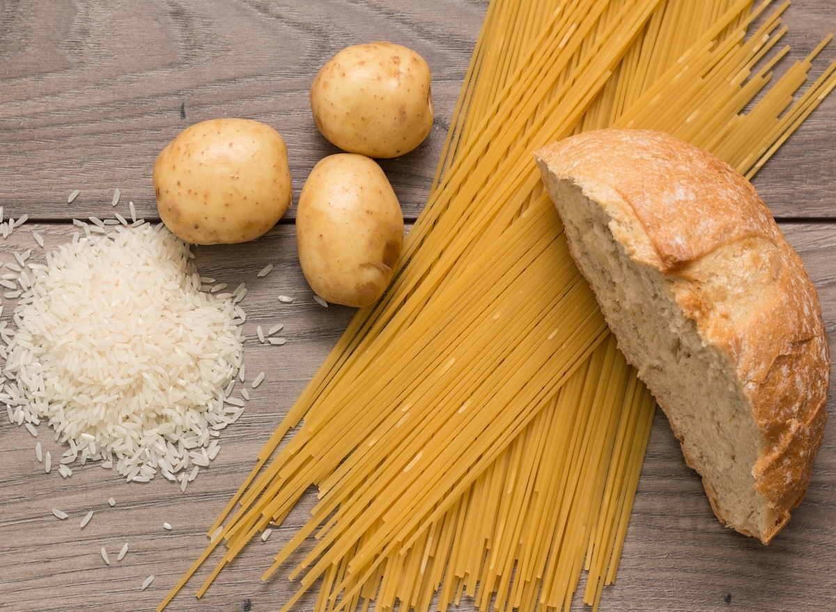 Spaghetti,,Rice,,Potatoes,,And,Bread,,On,A,Wooden,Table