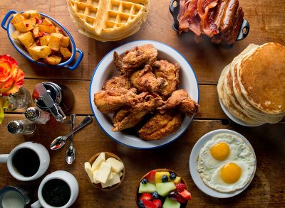 Fried Chicken. Southern breakfast. Buttermilk fried chicken, pancakes waffles, home fries, fried eggs, biscuits, crispy bacon, sausage, coffee, OJ, butter and jam. Classic Southern breakfast.