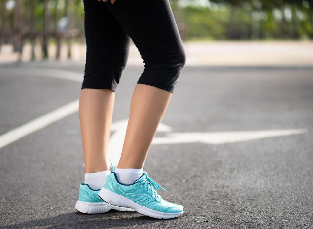 Closeup woman walking towards on the road side. Step, walk and outdoor exercise activities concept.