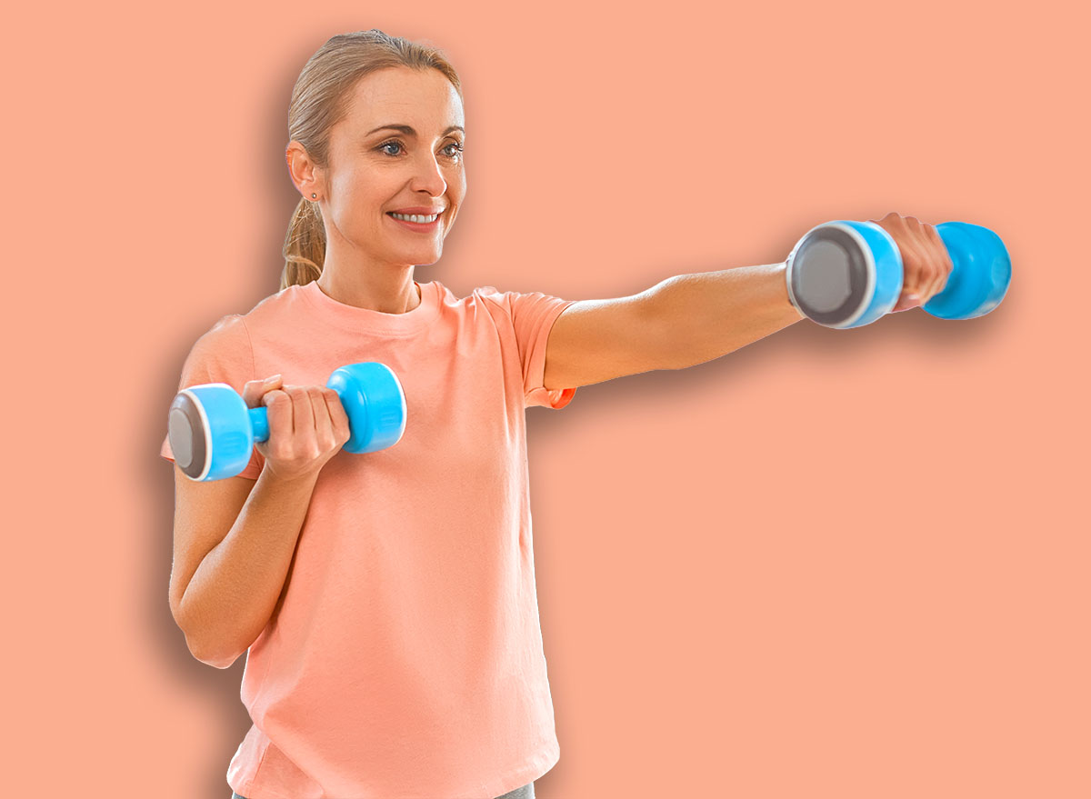 Sport, fitness and healthy lifestyle concept. Mature woman doing exercises with dumbbells at home. How to stay healthy in quarantine.