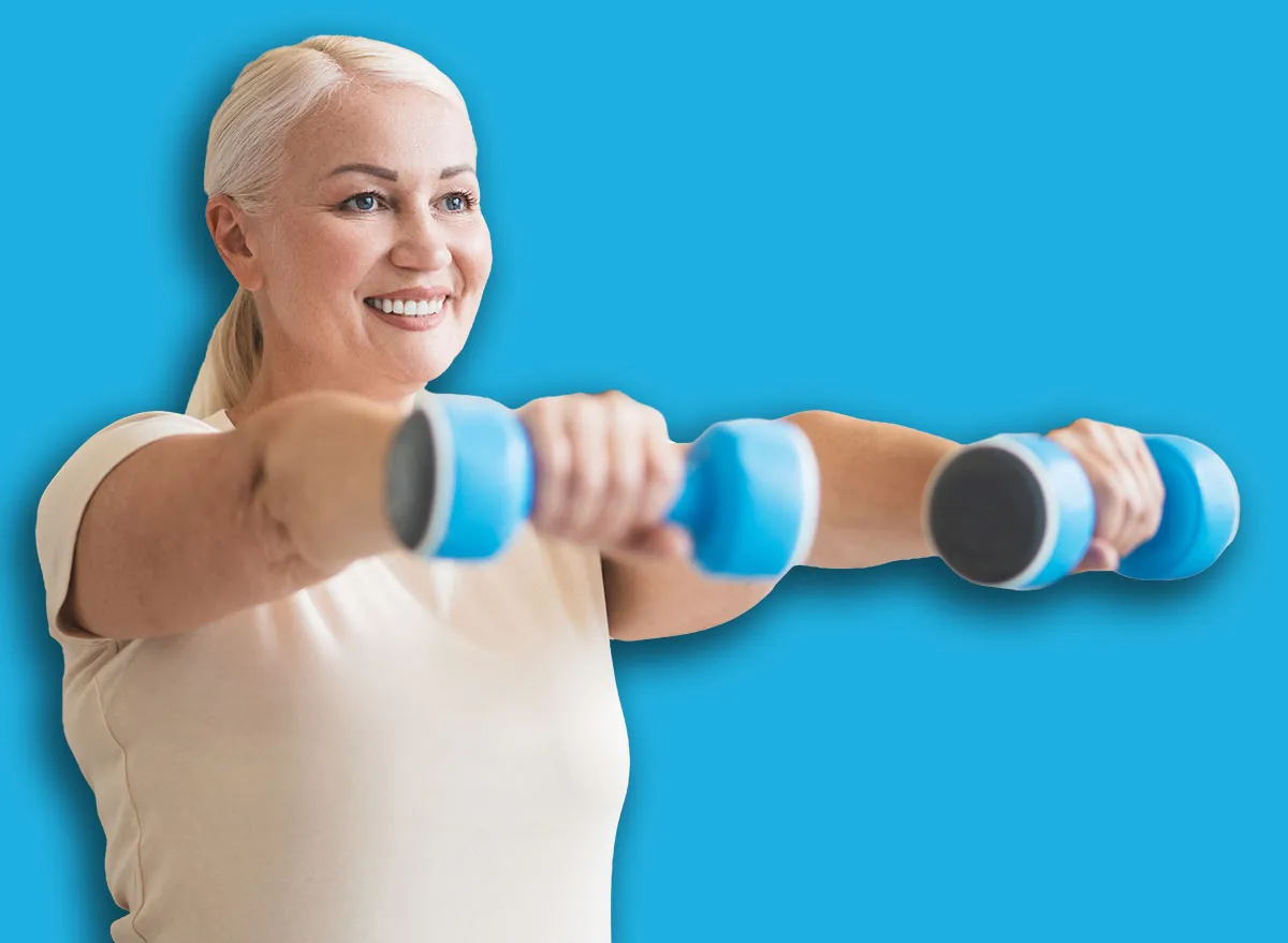 Joyful woman working out with hand weights