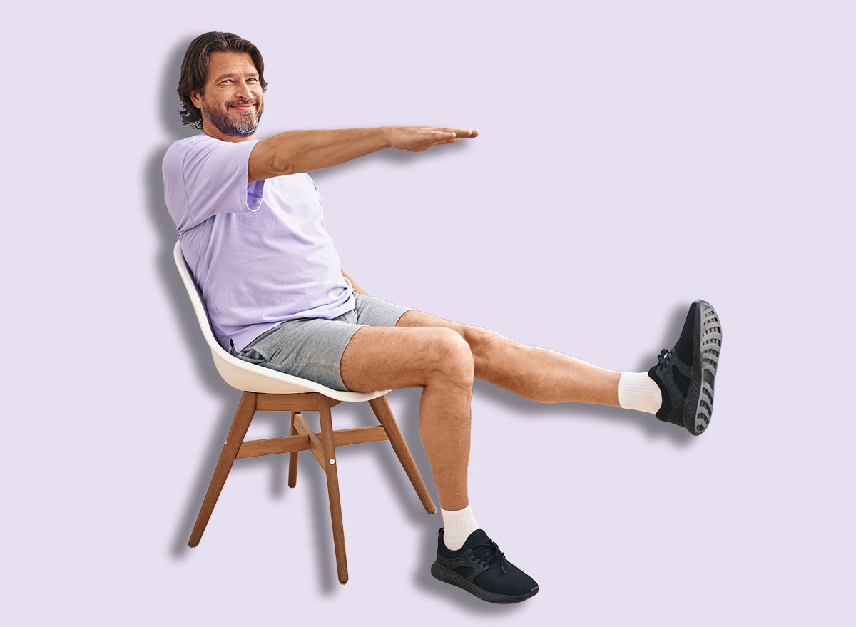 Middle age man smiling confident sitting on chair stretching at sport center